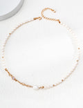 Liquid Metal pearl necklace in vintage gold arranged in a circle, with sculpted accents and an extension chain