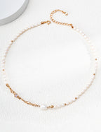 Liquid Metal pearl necklace in vintage gold arranged in a circle, with sculpted accents and an extension chain