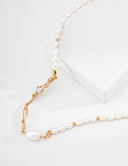 Close view of the vintage gold Liquid Metal pearl necklace, showing sculpted links and pearl accents on a white display