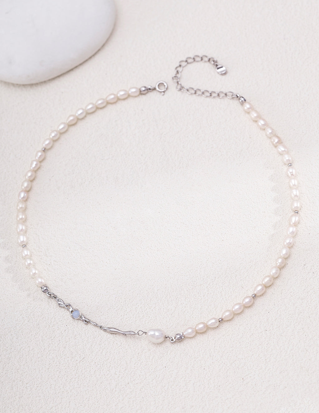 Liquid Metal pearl necklace in platinum silver arranged in a circle with sculpted accents and an extension chain