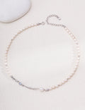 Liquid Metal pearl necklace in platinum silver arranged in a circle with sculpted accents and an extension chain