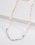 Close view of the platinum silver Liquid Metal pearl necklace, showing flowing metal accents on a white display