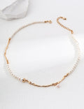 Geometric Baroque pearl necklace in vintage gold arranged in a circle, with irregular metal accents and a small pearl drop