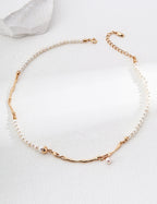 Geometric Baroque pearl necklace in vintage gold arranged in a circle, with irregular metal accents and a small pearl drop