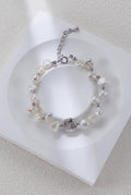 Celestial Charm pearl bracelet in platinum silver on a white display, with round spacers and a textured centerpiece