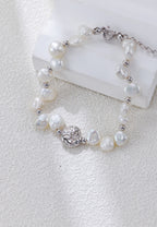 Close view of the Celestial Charm pearl bracelet in platinum silver, with irregular pearls and a textured round centerpiece