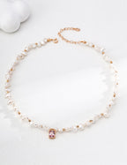 Baroque pearl necklace arranged in a circle, with vintage gold spacers and a pink crystal pendant at the center