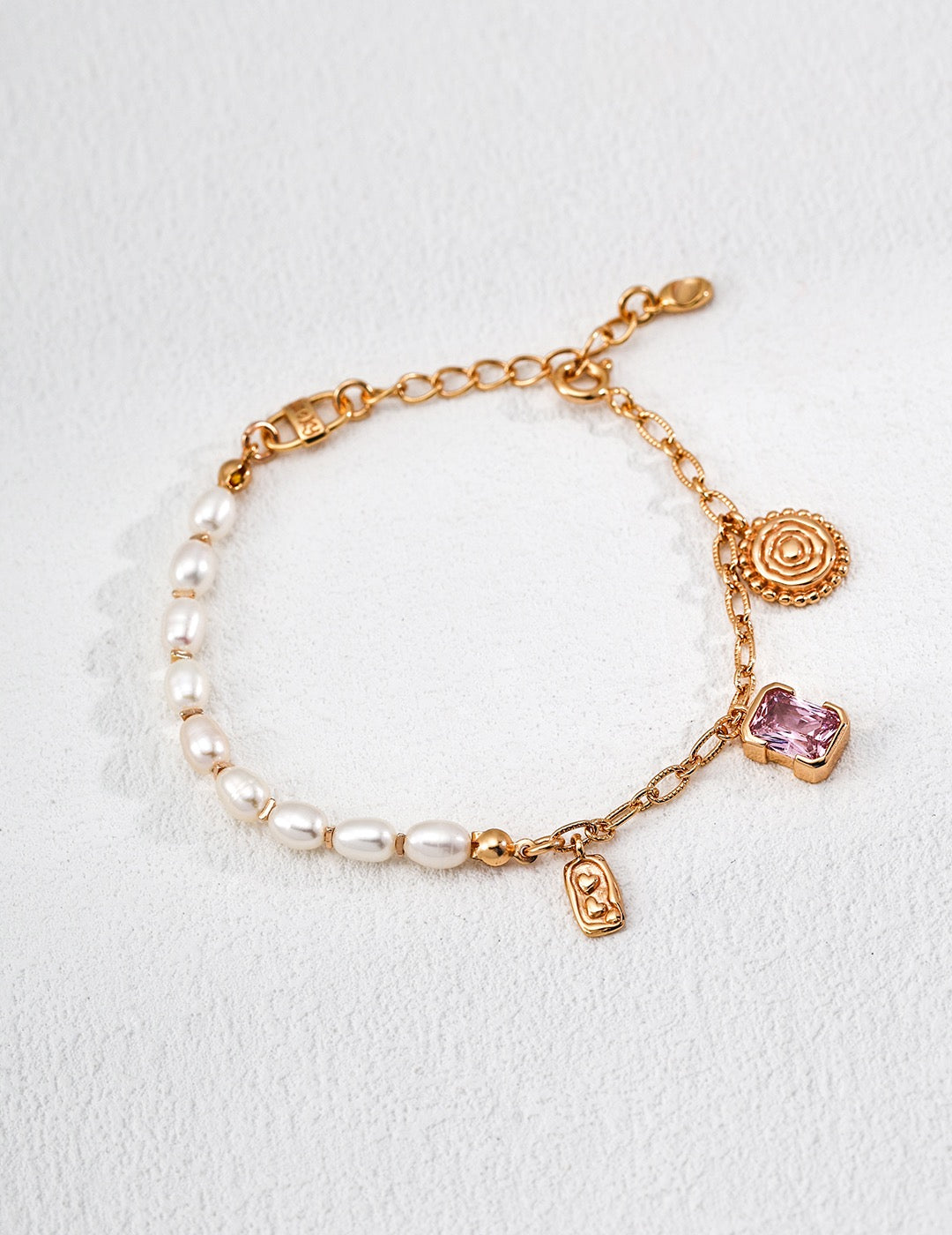 Enchanted Pink Charm bracelet with pearls on one side and a vintage gold chain, pink crystal and small charms on the other