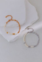 Vintage gold and platinum silver pearl bracelets displayed together, with linked accents and adjustable extension chains